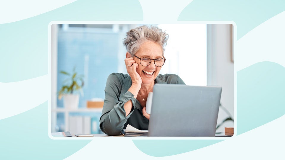 A woman reading retirement messages on her computer